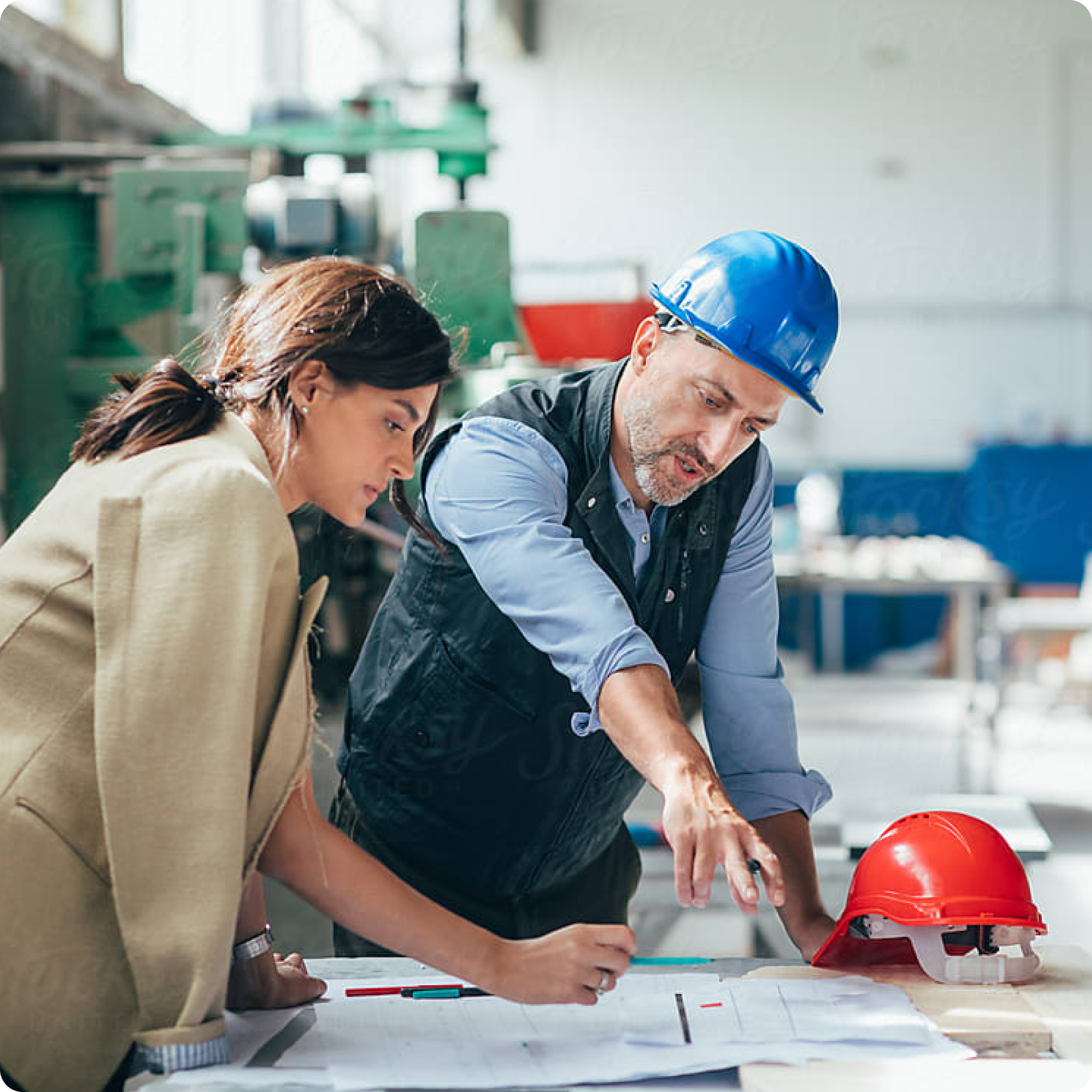 Two people discussing manufacturing plans